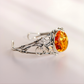 sterling Silver bracelet with a large amber stone on a light gray background