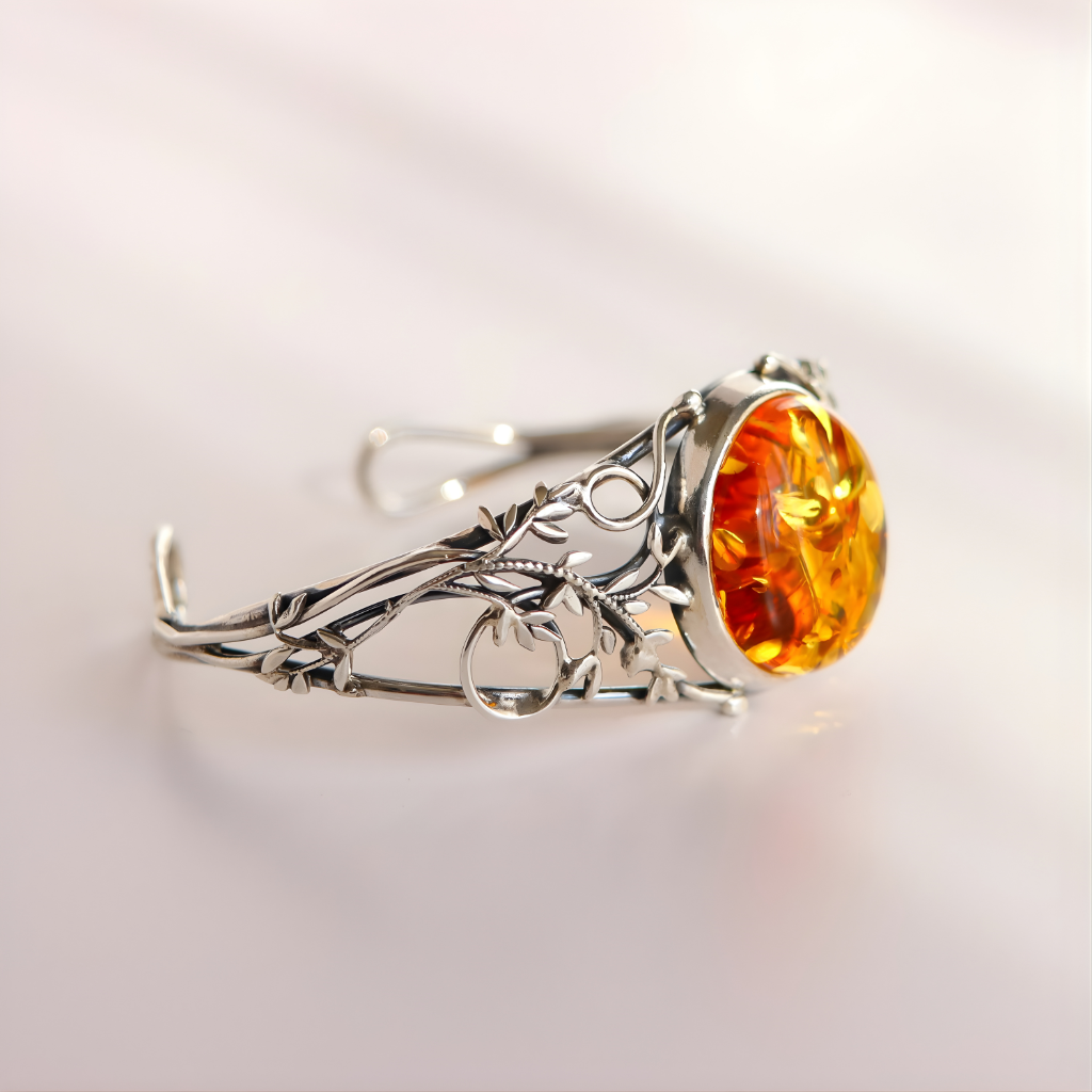 sterling Silver bracelet with a large amber stone on a light gray background
