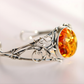 sterling Silver bracelet with a large amber stone on a light background