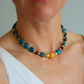 Beaded Necklace with multicolored beads worn by a person against a neutral background