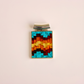 Colorful pixelated turquoise pendant necklace on a beige background