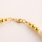 Gold Pearl Necklace with beaded design on a light background