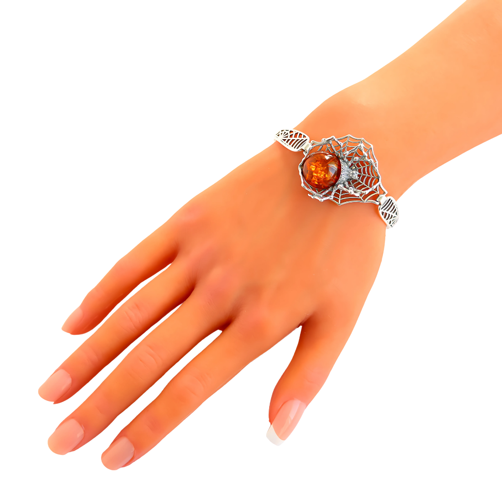 Baltic Cognac Amber Spider Bracelet in sterling silver on wrist.