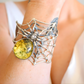 Close-up of baltic green amber stone set in sterling silver spider cuff amber bracelet