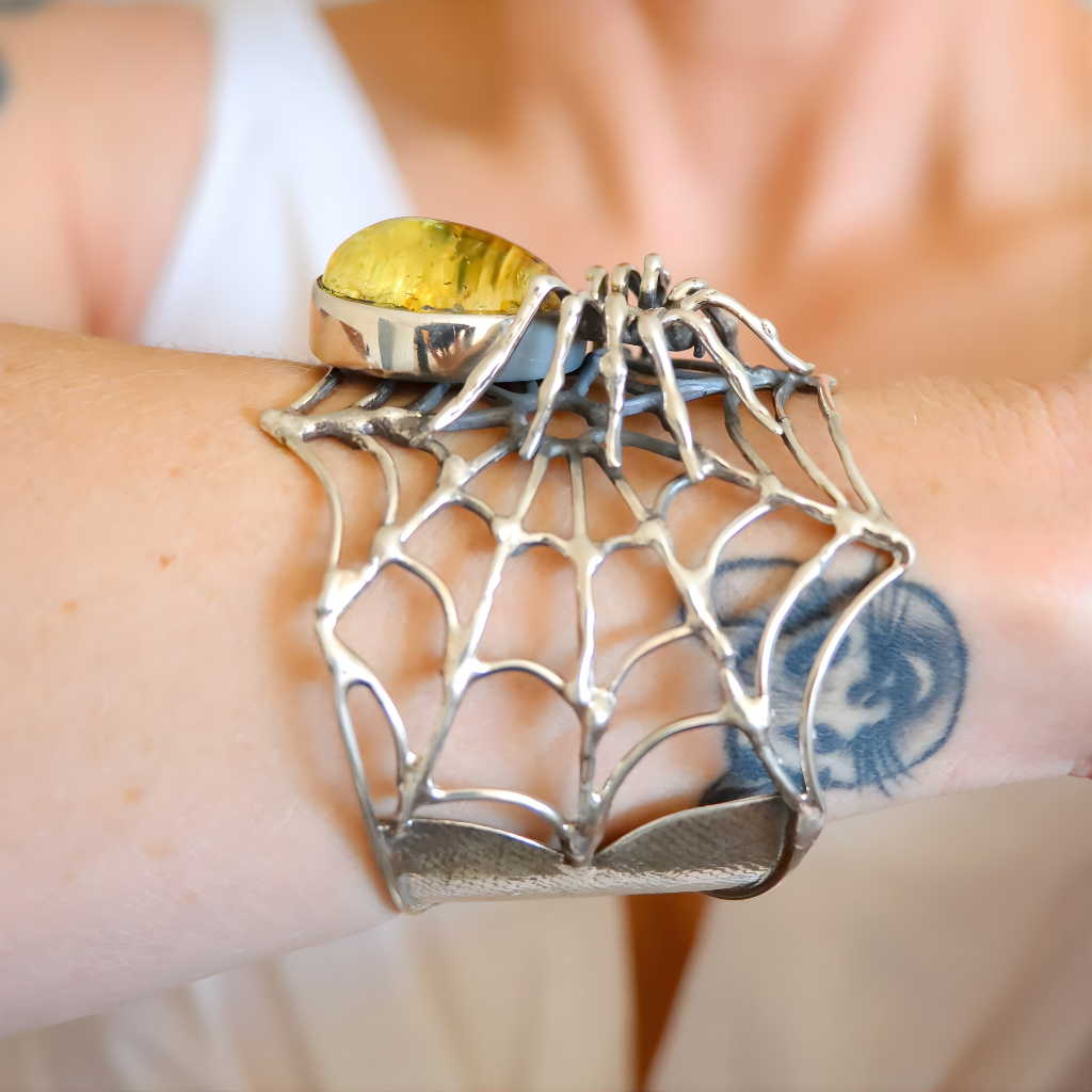Handmade sterling silver amber bracelet with spider motif and baltic green amber
