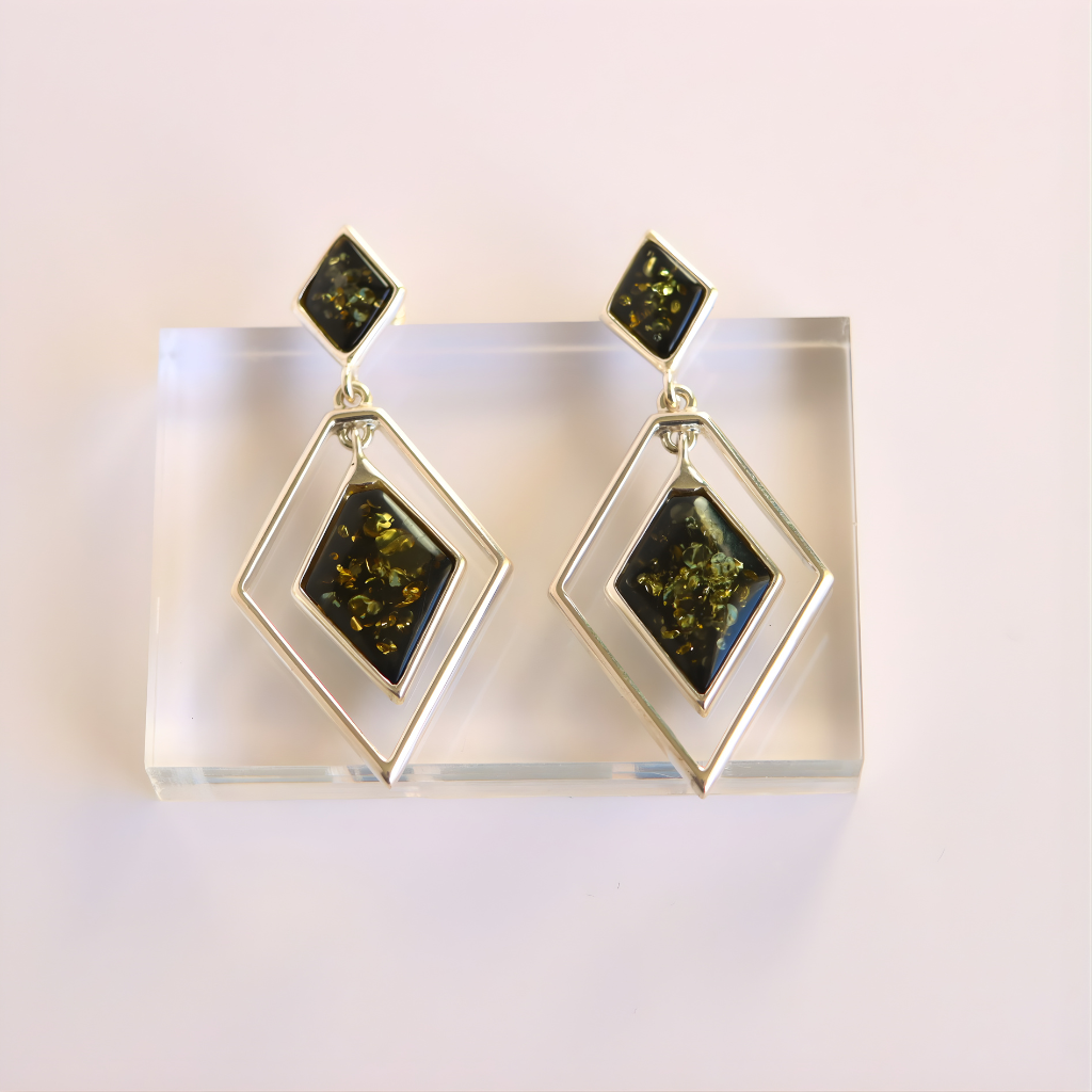 Pair of green amber earrings with geometric design on a white background