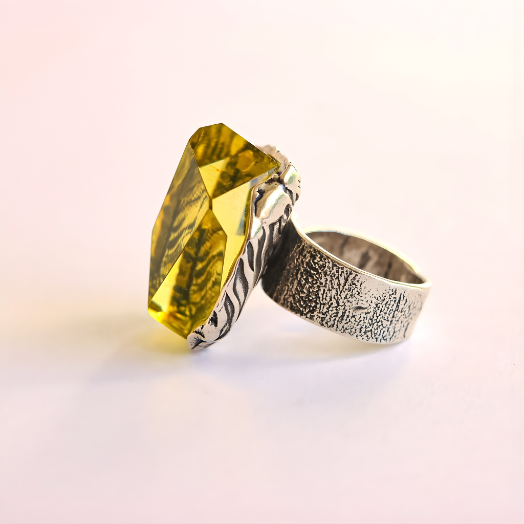 amber Ring with a large yellow gemstone on a light pink background