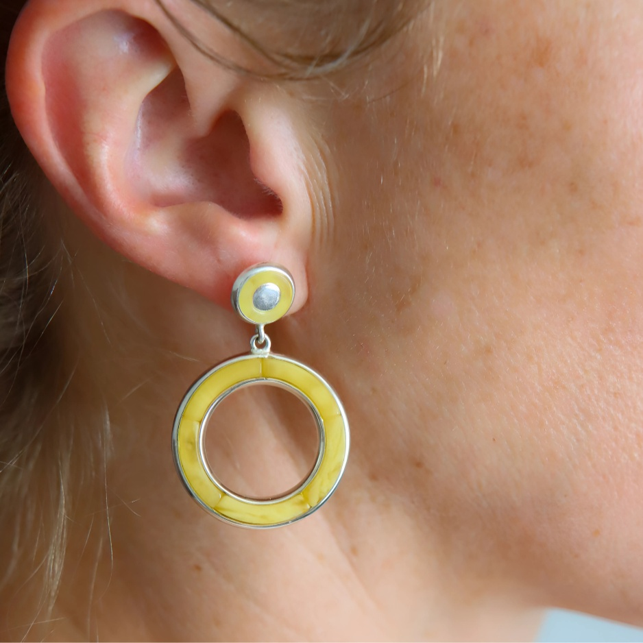 Close-up of an ear wearing butterscotch amber earring.