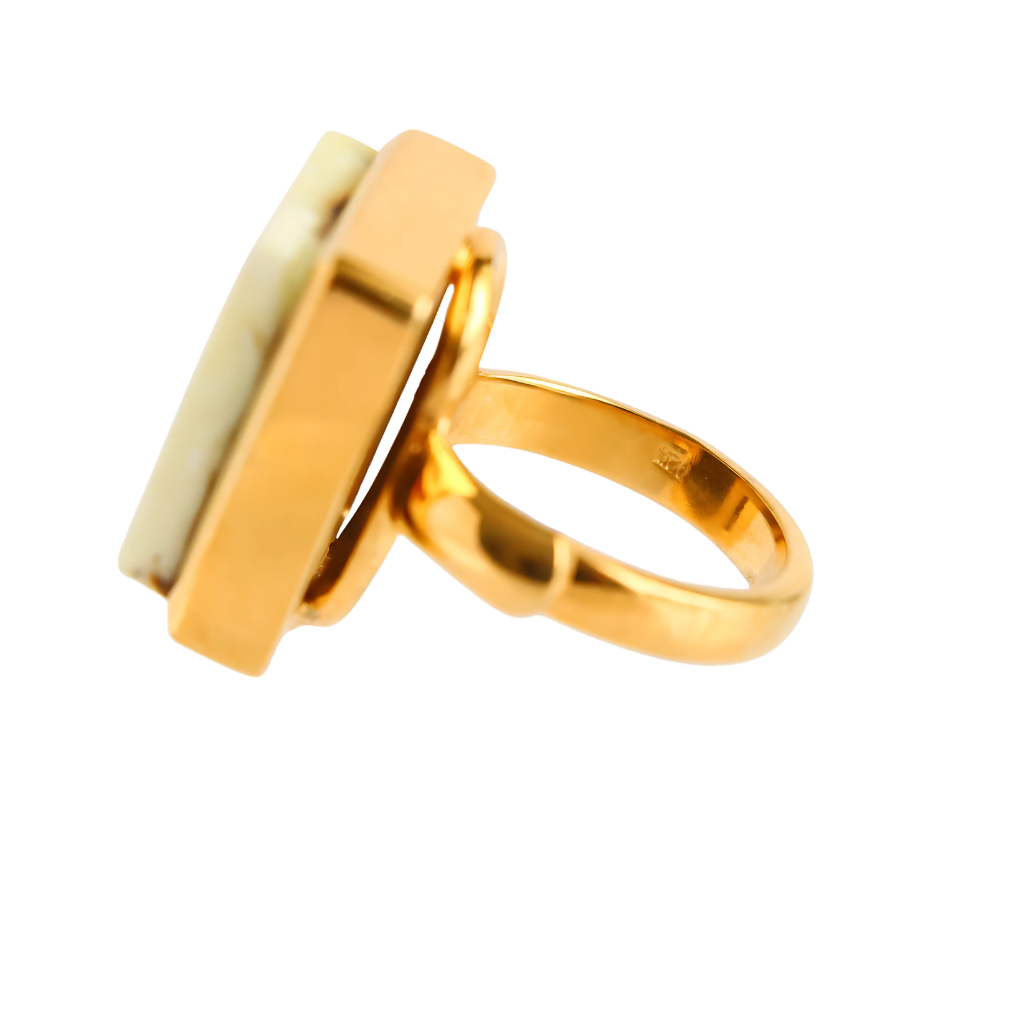 Butterscotch amber ring in 14k gold setting with marbled white stone.