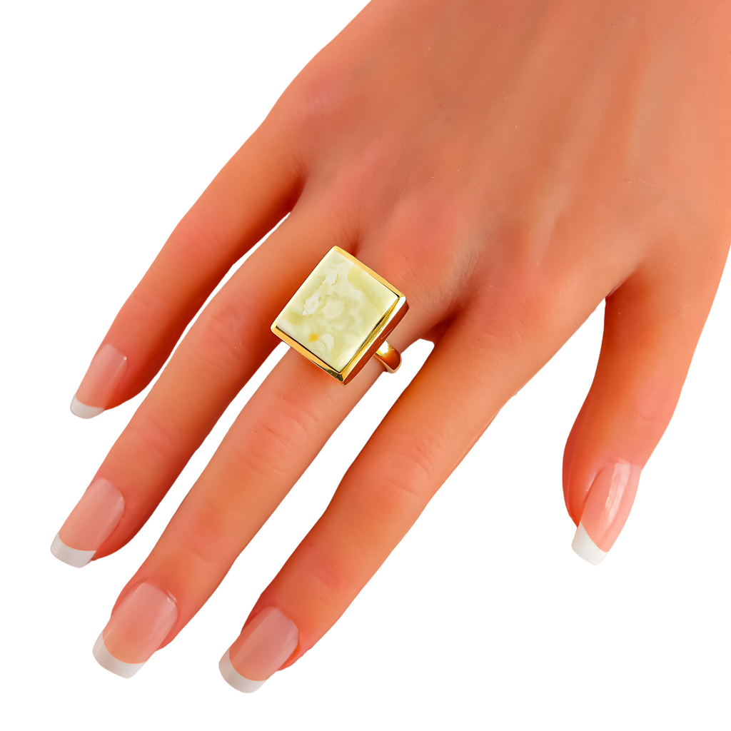 Butterscotch amber ring in 14k gold on hand, elegant statement piece.