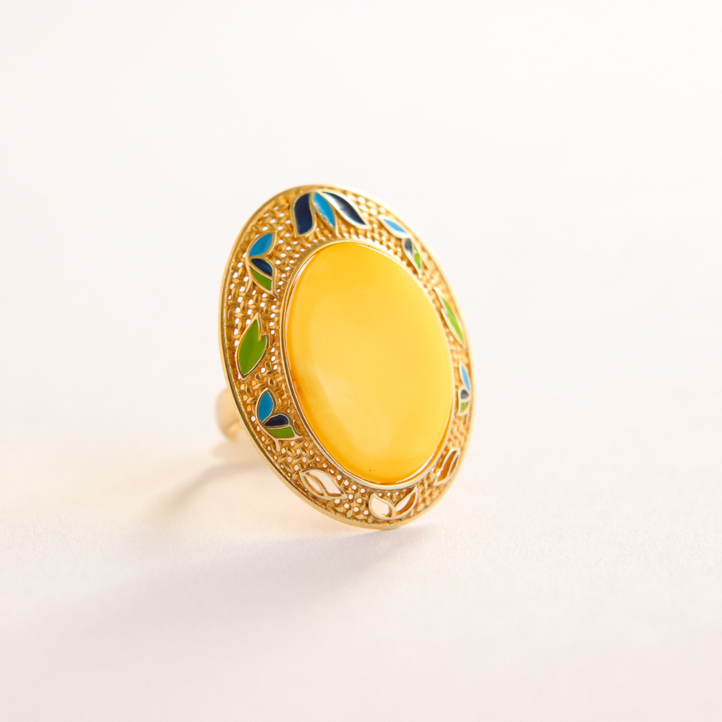 Gold butterscotch amber ring with a yellow stone and colorful accents on a white background
