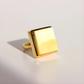 Gold square amber ring on a light gray background