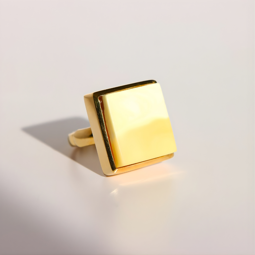 Gold square amber ring on a light gray background