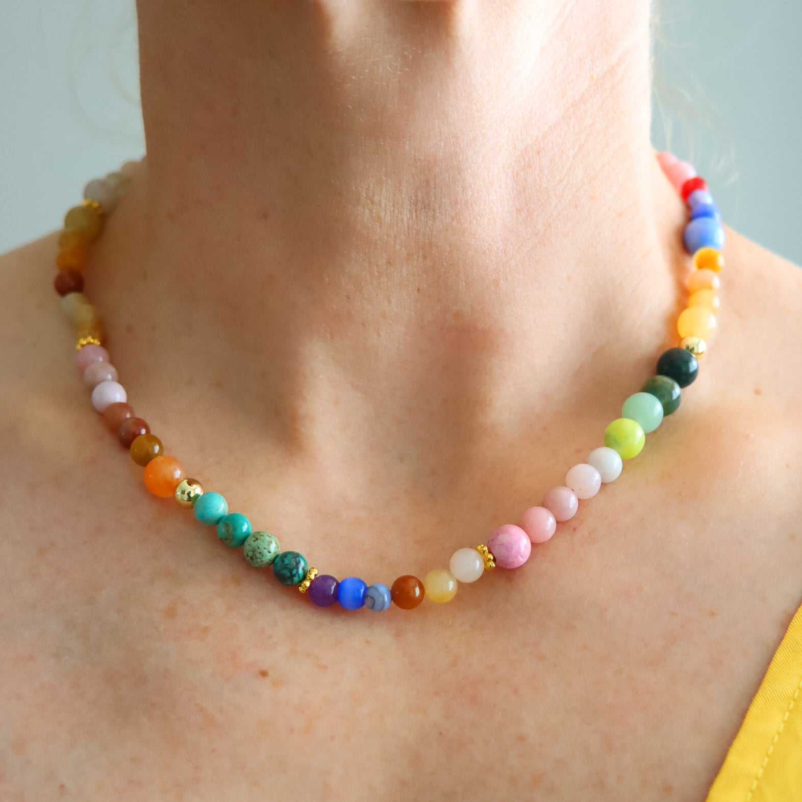 Close-up of colorful Candy Crush necklace with genuine opal, turquoise, jade beads, and 18k gold-filled accents on a neck