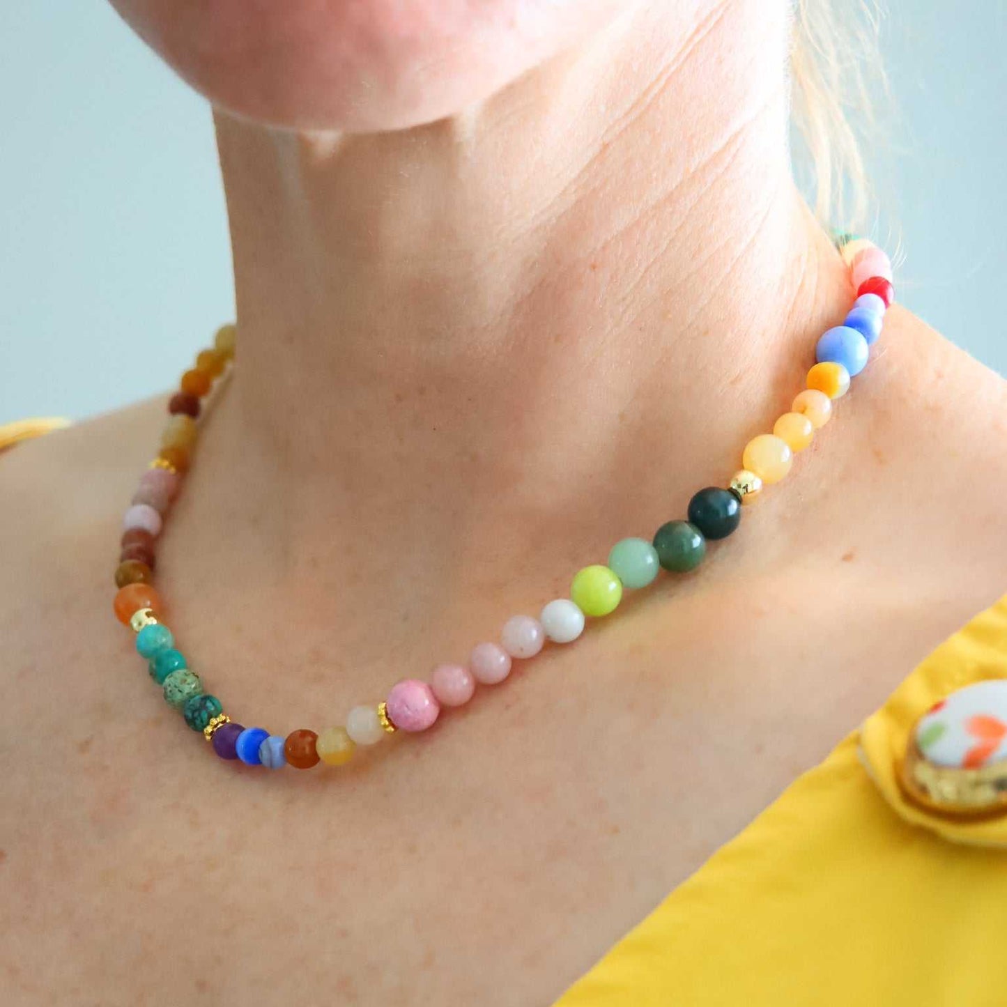 Close-up of colorful Candy Crush necklace with genuine Australian pink opal, turquoise, jade beads, and 18k gold-filled accents worn on collarbone