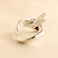 bee ring with open silver band on beige background