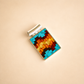 Colorful rectangular turquoise necklace pendant with a silver setting on a beige background