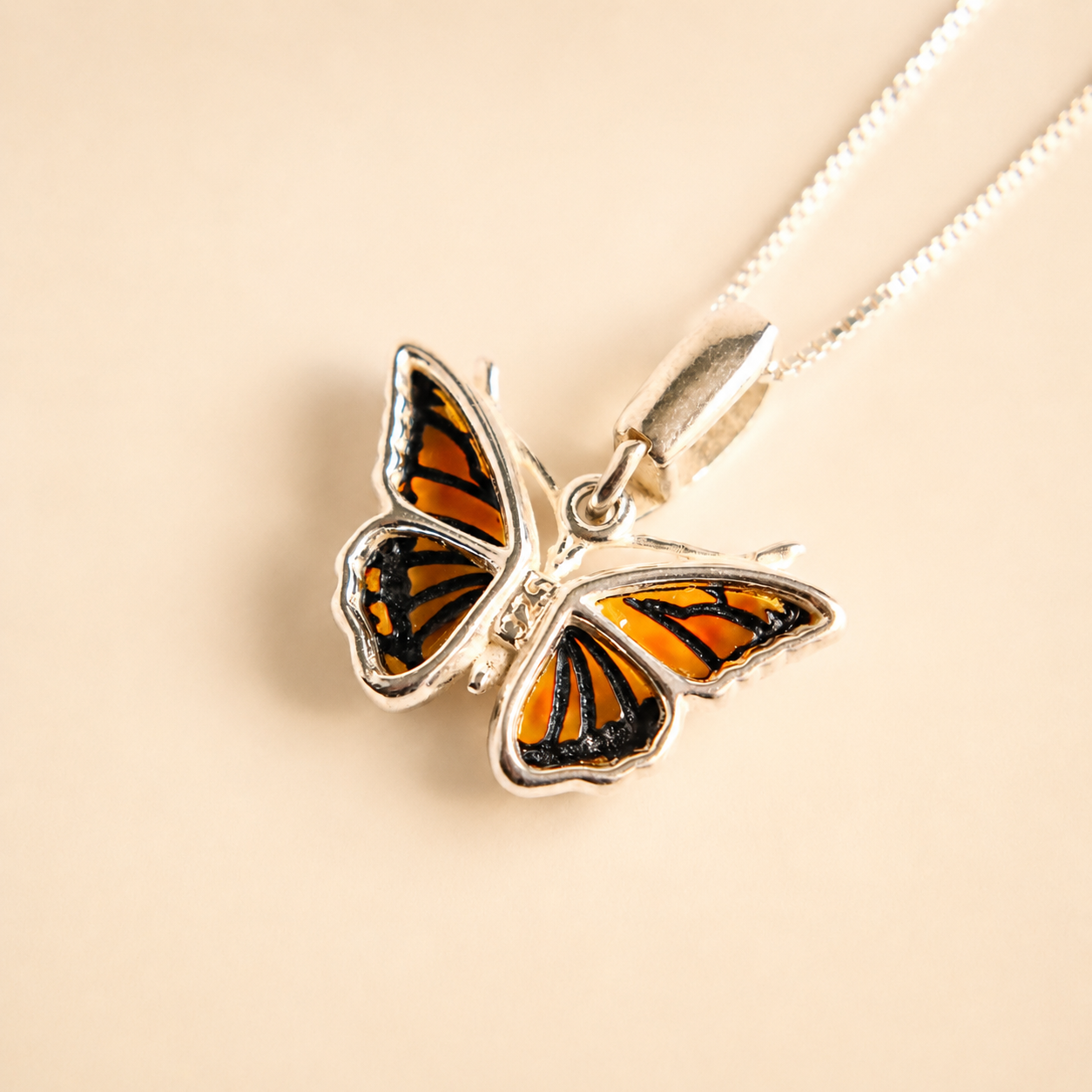 Butterfly necklacet on a beige background