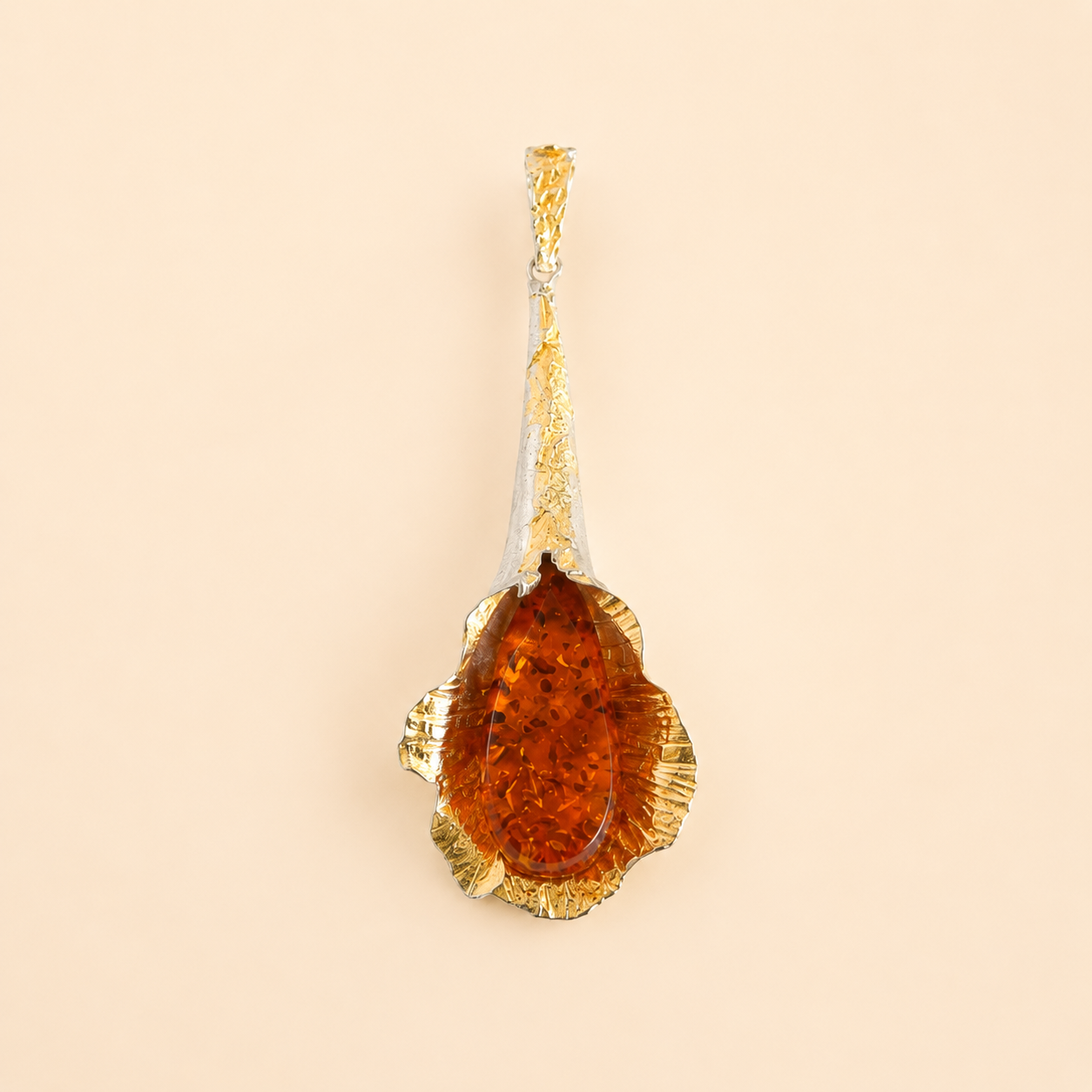 Gold amber necklace pendant with a large amber stone on a beige background