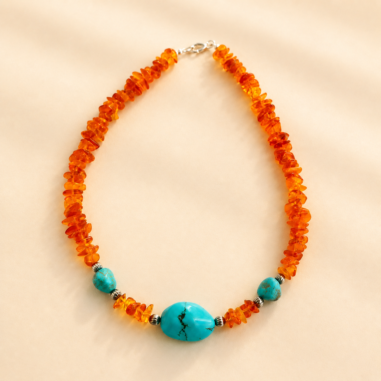 beaded Necklace with orange beads and turquoise stones on a beige background