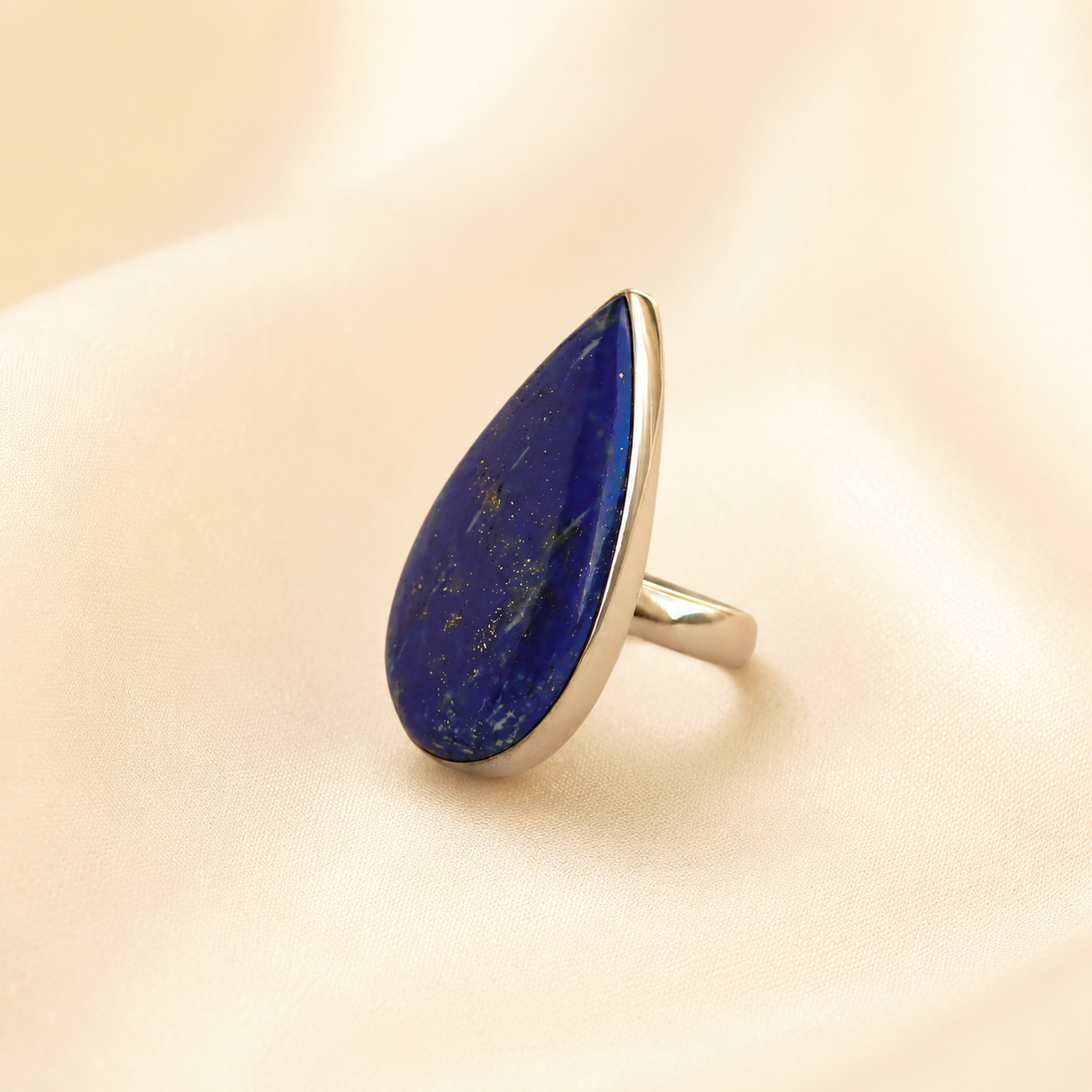 lapis lazuli Ring with a blue stone on a beige background