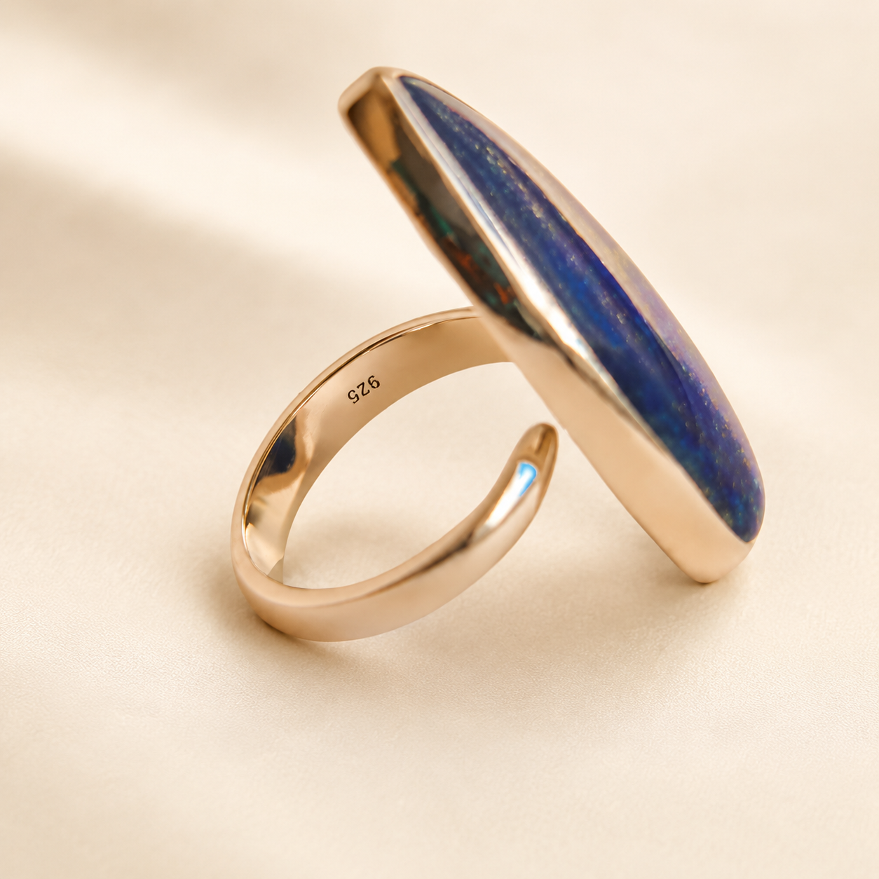 lapis lazuli ring with a blue stone on a beige background