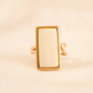 Gold white amber ring with a rectangular face on a beige background