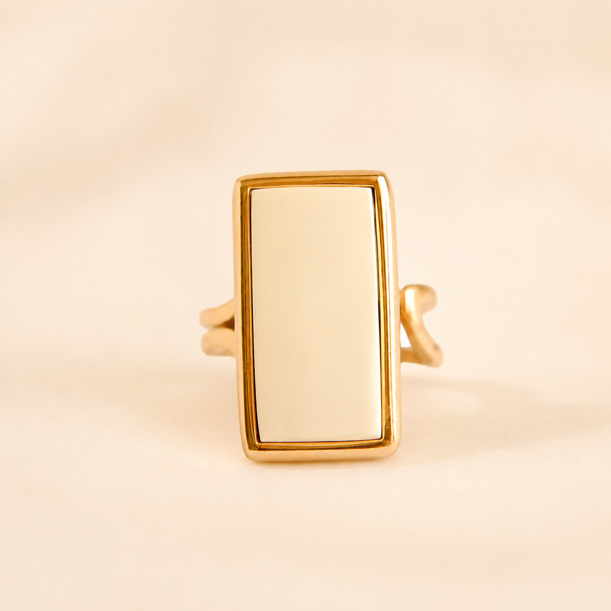 Gold white amber ring with a rectangular face on a beige background