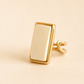 Gold amber ring with a rectangular design on a beige background