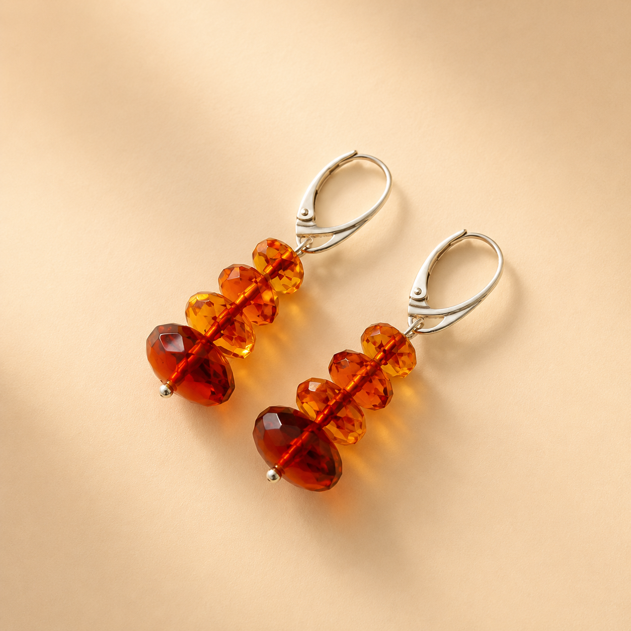 Amber bead drop earrings on a beige background
