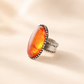 Medieval Statement Ring with a large orange gemstone and silver band on a beige background