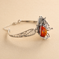Silver amber bracelet with an amber stone on a beige background