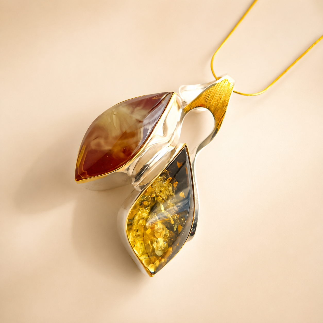 amber necklace with leaf-shaped design featuring amber inlay on a beige background