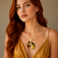 Woman wearing a gold amber necklace with a pendant against a neutral background