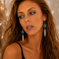 Model wearing feather drop earrings with turquoise gemstone.