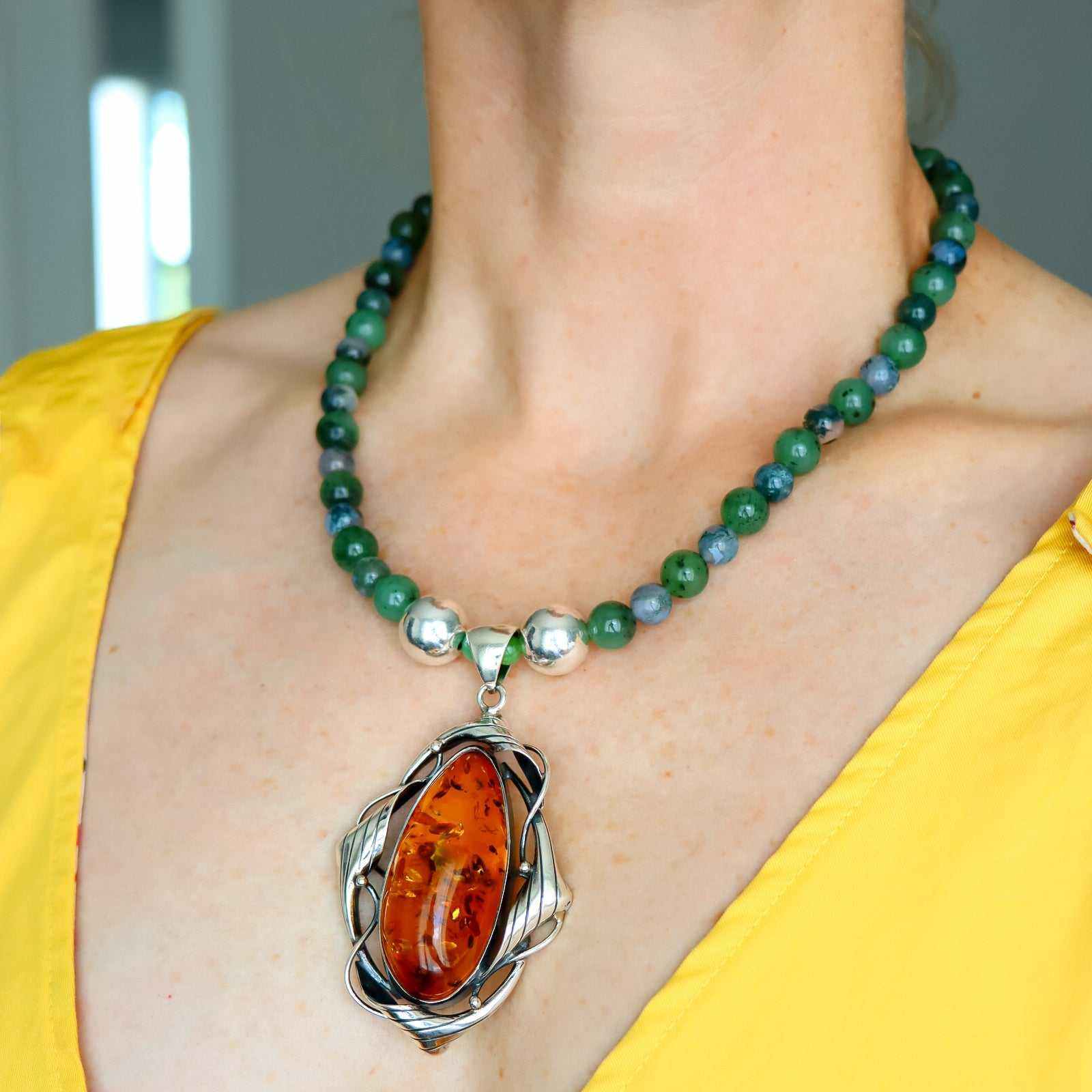 Cognac amber statement necklace with green Canadian jade, moss agate beads, and sterling silver pendant
