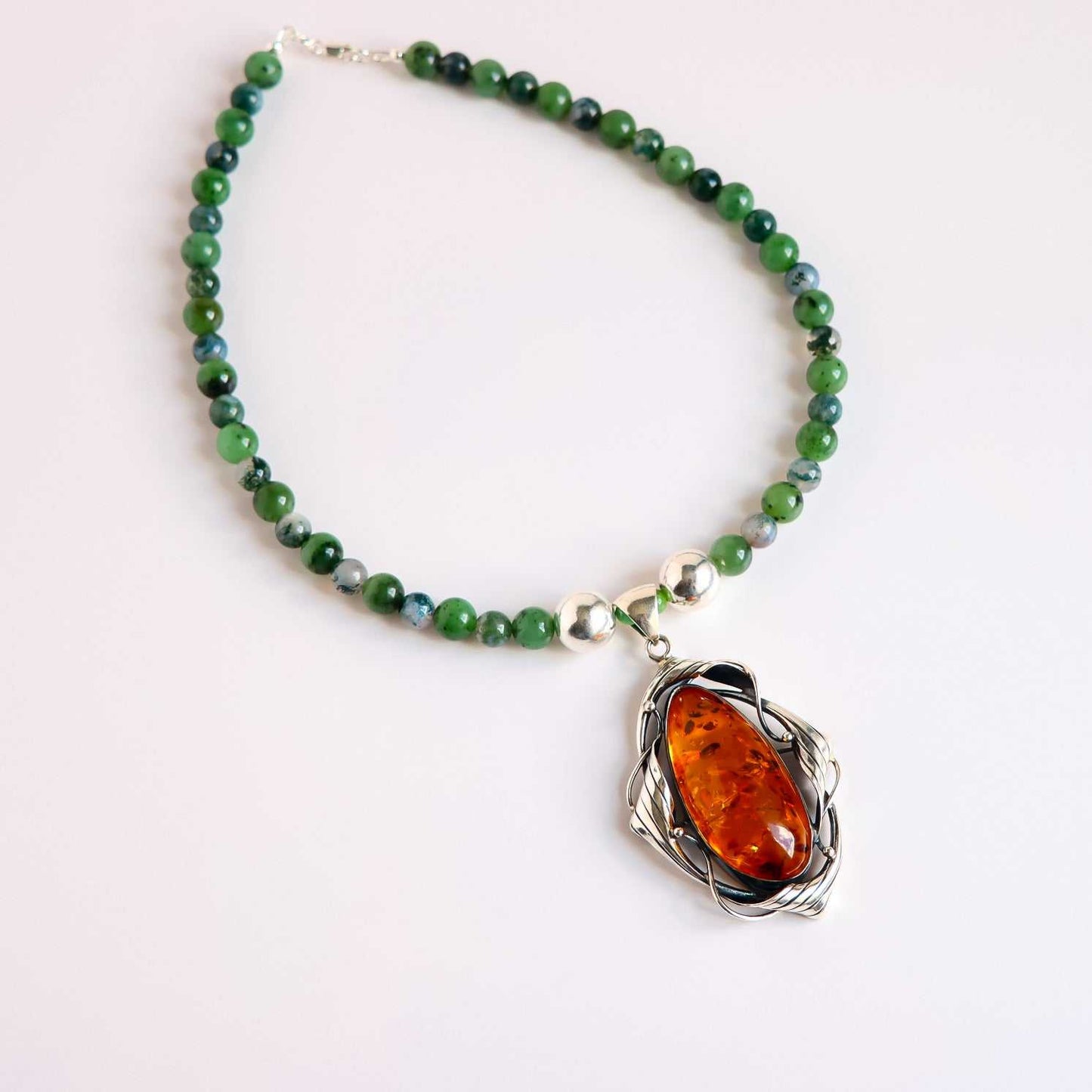 Cognac amber statement necklace with Canadian jade, green moss agate beads, and sterling silver pendant handcrafted in the USA
