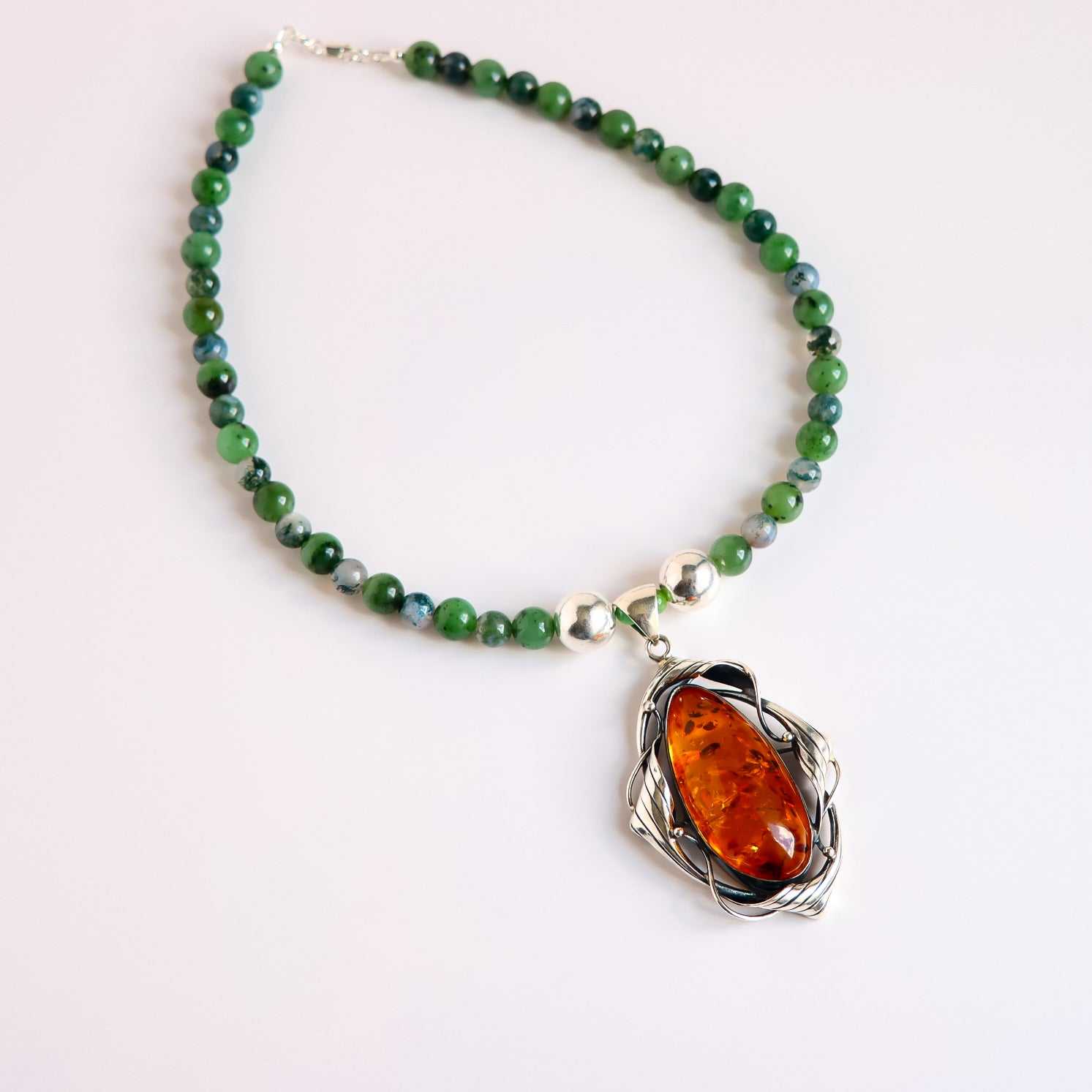 Cognac amber statement necklace with Canadian jade, green moss agate beads, and sterling silver pendant handcrafted in the USA