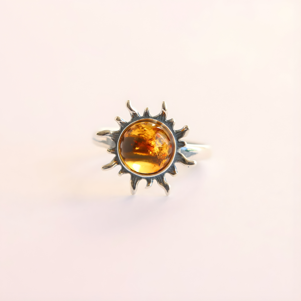 Sun-shaped amber ring with a amber stone on a light background
