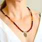Handmade Baltic amber beaded necklace on model showcasing multicolor amber beads and silver floral spacer details