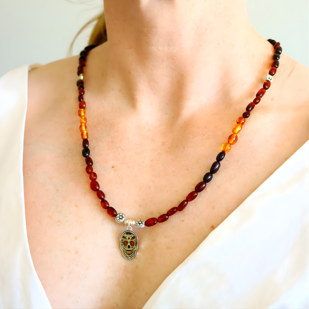 Handmade Baltic amber beaded necklace on model showcasing multicolor amber beads and silver floral spacer details.