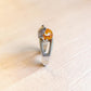 Side view of sterling silver frog ring with Baltic amber cabochon and textured open band.