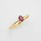 Genuine 14k gold garnet and diamond ring with oval cut gemstone.