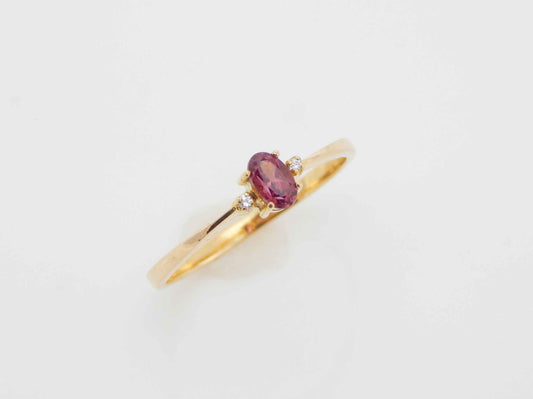 Genuine 14k gold garnet and diamond ring with oval cut gemstone.