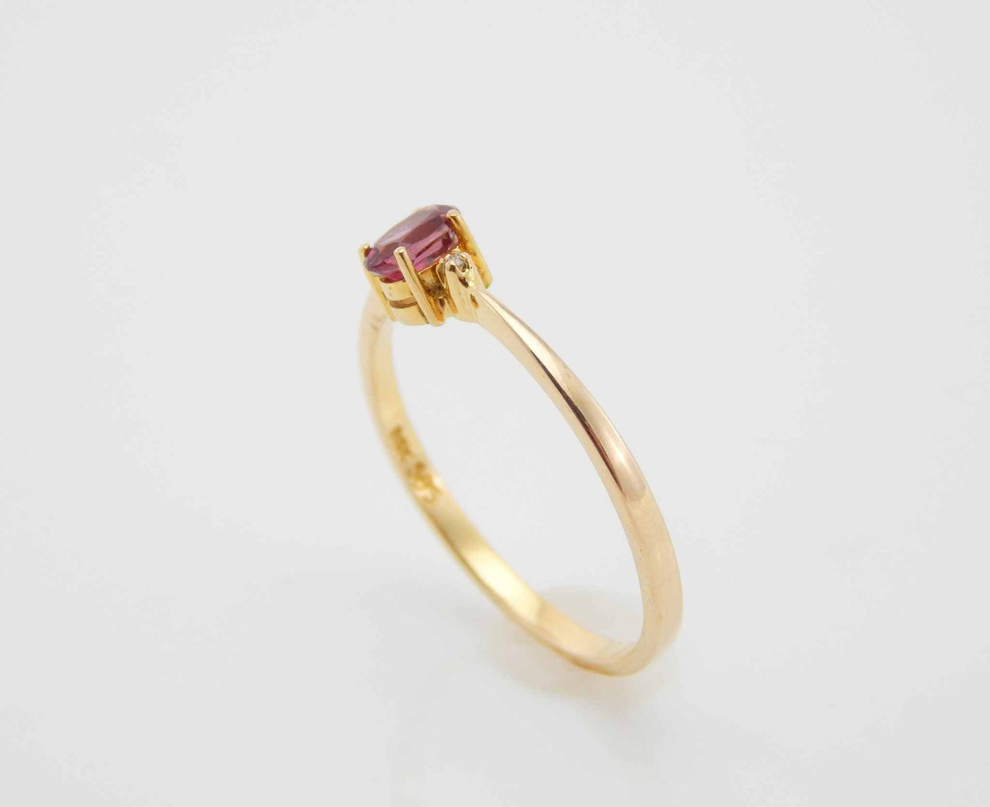 Genuine 14k gold ring with garnet and diamond in prong setting.