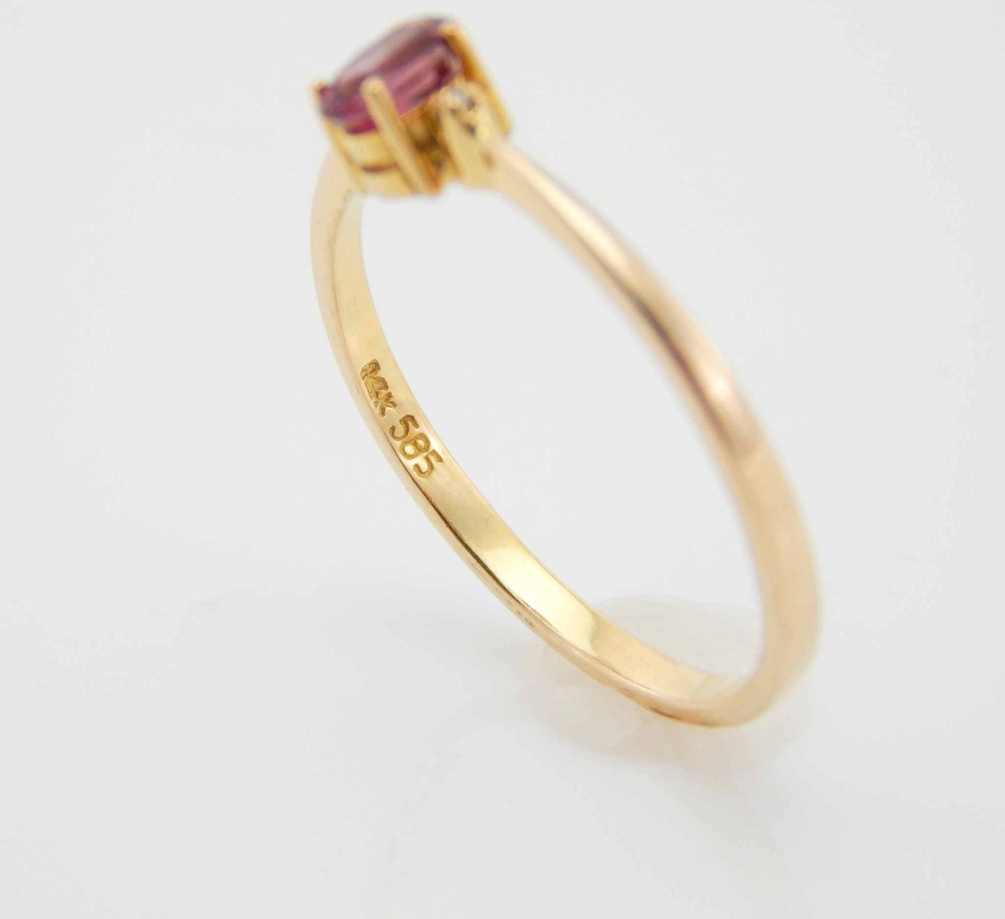 Genuine 14k gold ring with garnet and diamonds in prong setting.