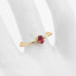 Genuine 14k gold ring with garnet and diamond on display.