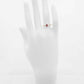 Genuine 14k gold garnet and diamond ring on mannequin hand.