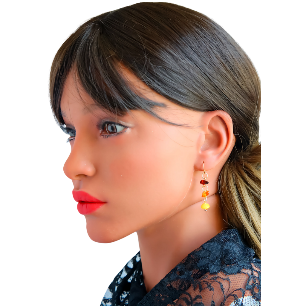 Genuine Baltic Amber dangle earrings with cherry, cognac, and butterscotch beads on gold-plated brass, worn by model.