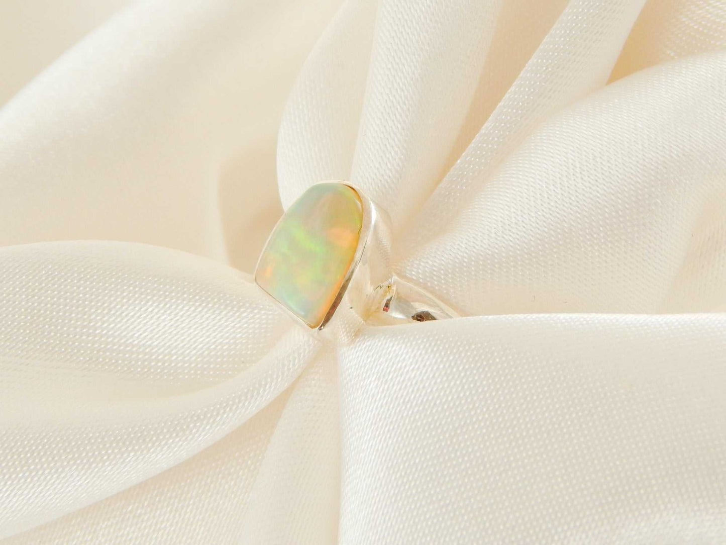Genuine Ethiopian opal ring in 925 sterling silver with vivid colors, asymmetrical cut.